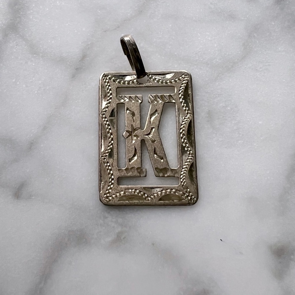 Mexican silver K charm